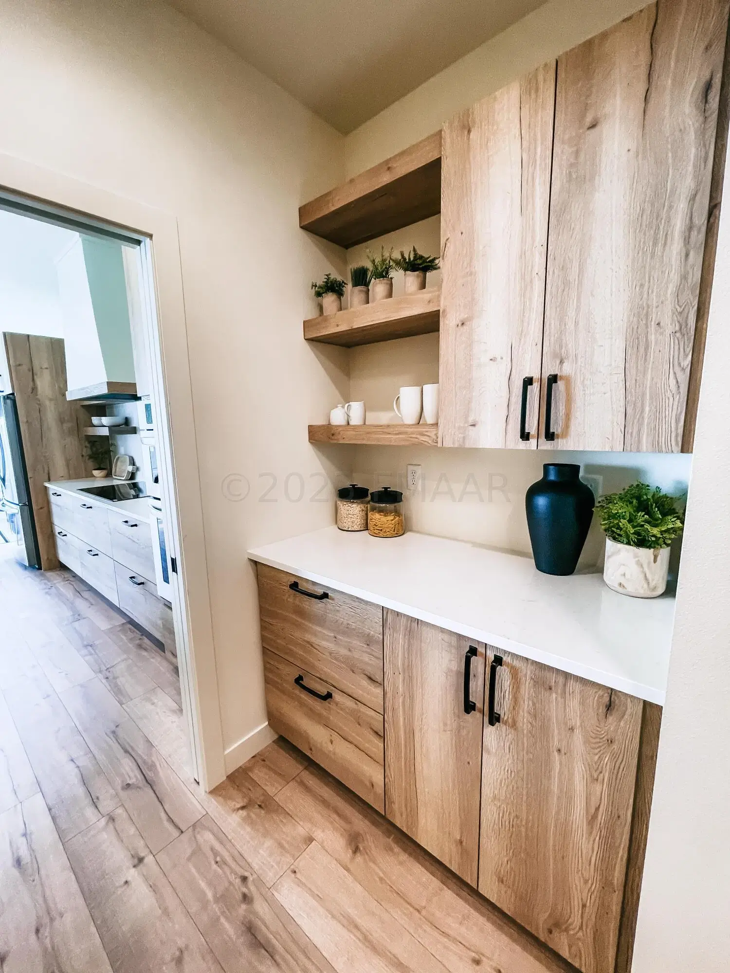 A Kitchen With Wood Cabinets And Shelves.