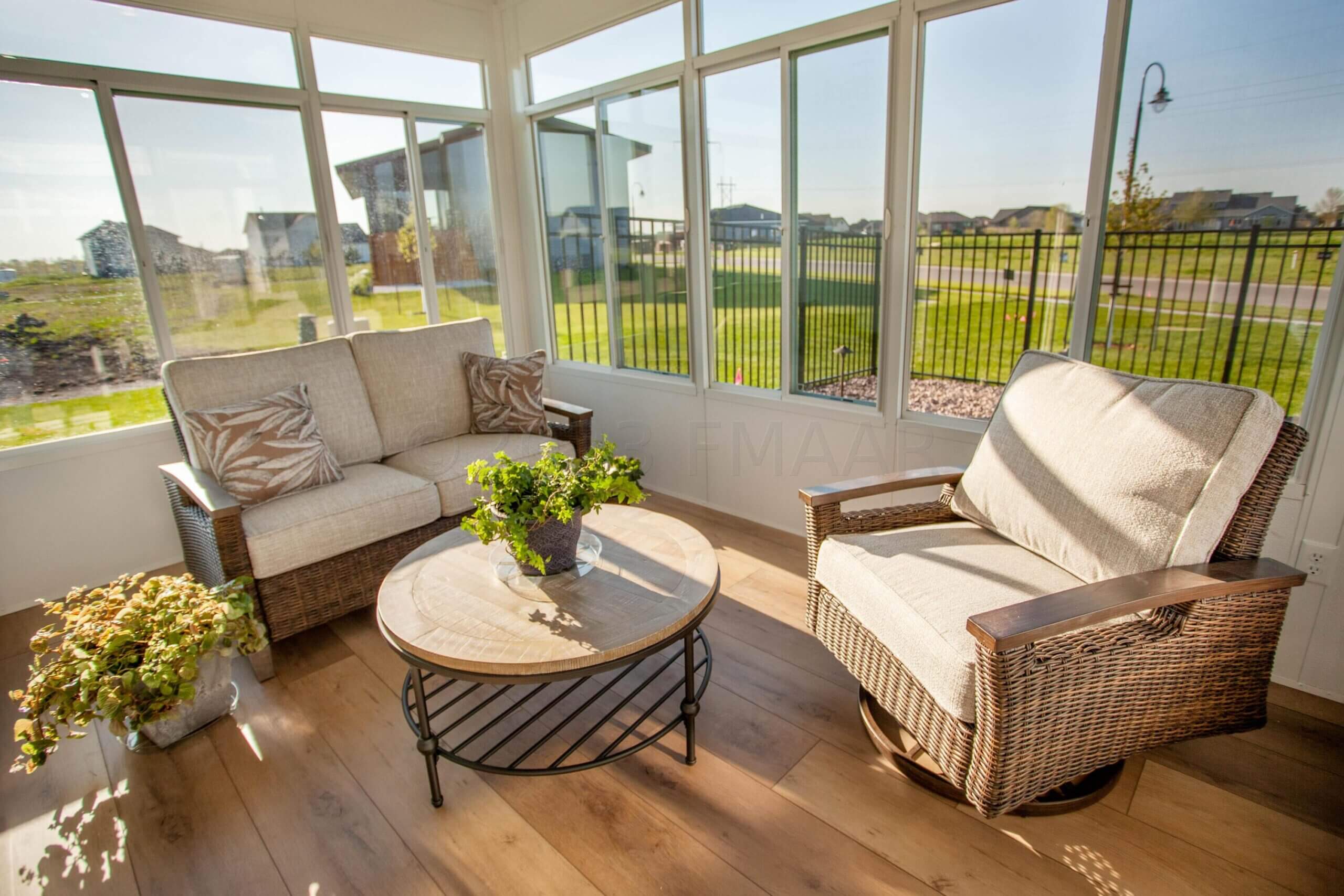 a sunroom with a couch and a table